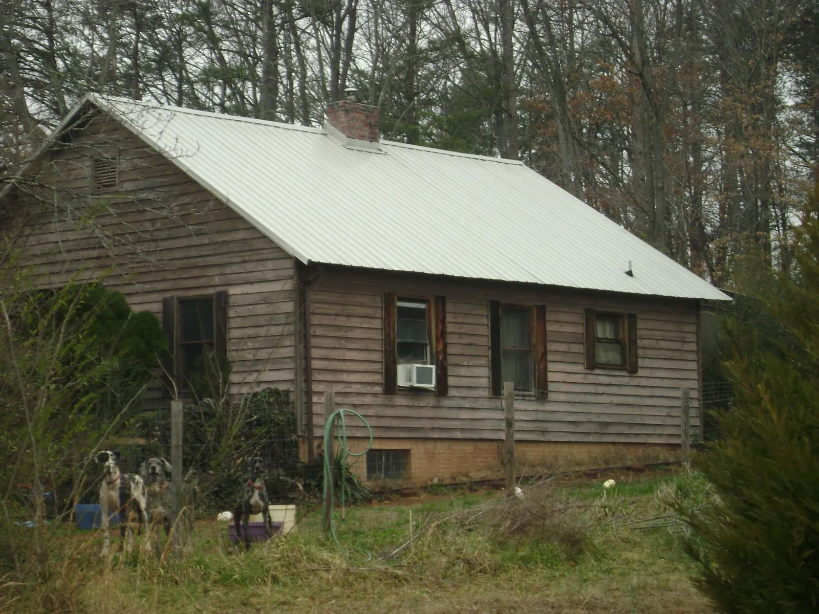 White metal roof on an old wood sided farmhouse, from a Asphalt Shingle Roof Repair job in Huntingdon